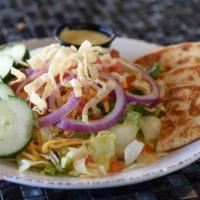 Mixed Greens · A blend of mixed greens, shredded cheddar cheese, cucumbers, red onions, tomatoes and crispy...