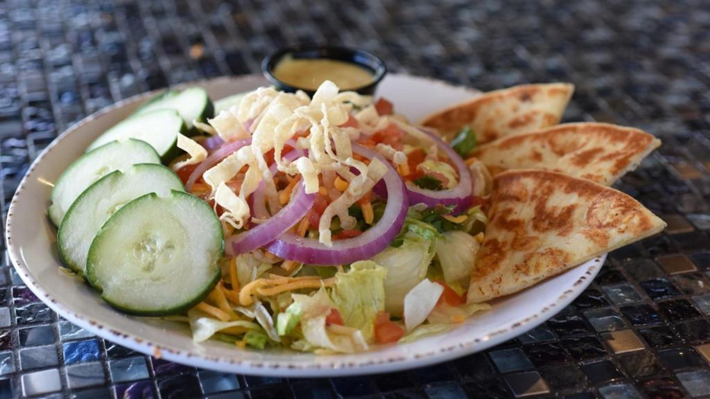 Mixed Greens · A blend of mixed greens, shredded cheddar cheese, cucumbers, red onions, tomatoes and crispy fried wontons served with your choice of salad dressing.