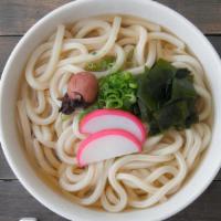 Nabeyaki Udon Noodles · Two pieces shrimp tempura, egg and vegetables over fat noodles in soup.