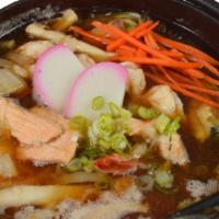 Seafood Sukiyaki · An assortment of seafood, vegetables, clear noodles, and tofu.