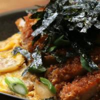 Katsudon · A bowl of rice with a deep-fried pork cutlet, egg, vegetables, condiments.