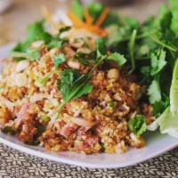 Nam Khao · Crispy rice salad-prepared with rice, curry paste, pork,  cured pork, coconut, green onion a...