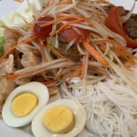 Tahd Thum Mak Hoong · Papaya salad platter served with cabbage, vermicelli noodles, pork rinds, and egg.