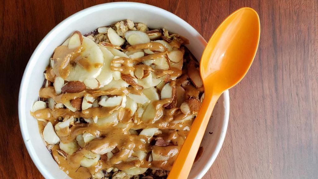 Nutty Bowl · BASE BLEND: Organic Acai, Almond Milk, Apple Juice, Peanut Butter, Bananas, Strawberries, Flax Seed. TOPPINGS: Organic Granola, Bananas, Almonds, Honey.