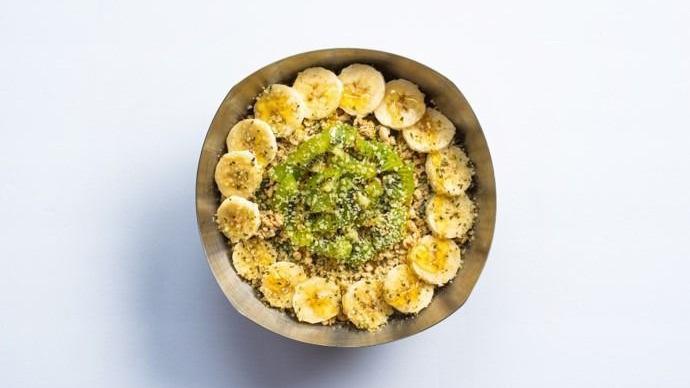 Green Bowl · BASE BLEND: Graviola, Almond Milk, Dates, Spirulina, Spinach, Kale, Strawberries, Bananas  TOPPINGS: Organic Granola, Bananas, Kiwi, Hemp Seeds, Honey