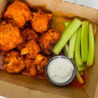 Buffalo Cauliflower Wings · Hot and spicy buffalo sauce covered cauliflower with a side of ranch dressing.