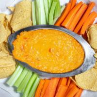 Buffalo Chicken Dip · A mix of cheeses with chicken, and buffalo sauce served warm with tortilla chips, carrots an...