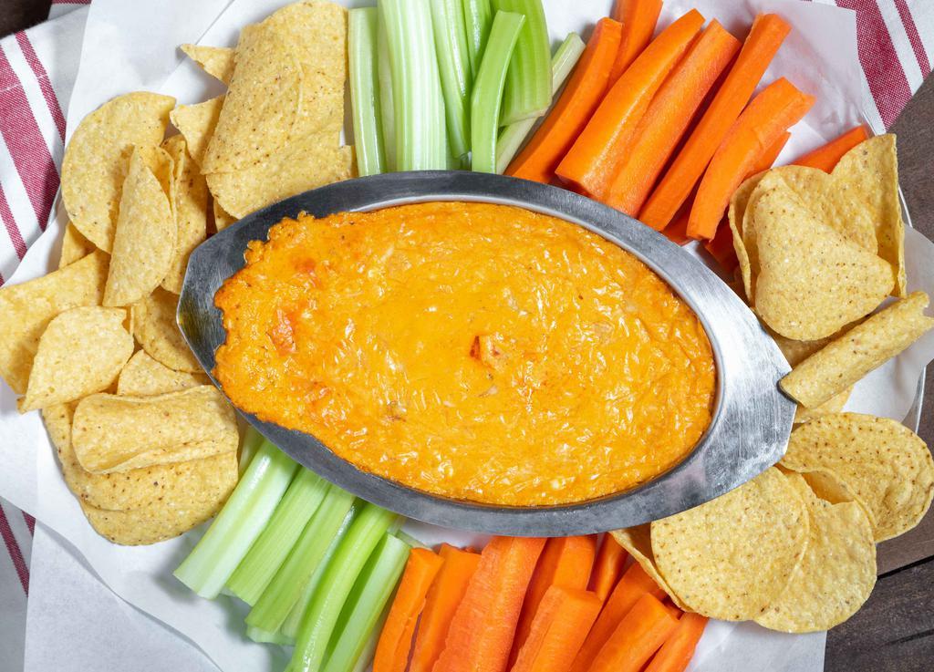 Buffalo Chicken Dip · A mix of cheeses with chicken, and buffalo sauce served warm with tortilla chips, carrots and celery.