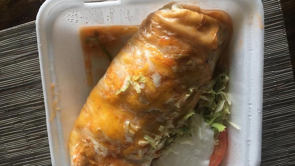 Burrito Mi Pueblo · rice, beans, cilantro, onion, sauce on top and on the outside on a Corner lettuce, tomato, sour cream.  meat of your choice.