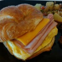 Breakfast Croissant · Scrambled eggs, cheddar cheese, your choice of sausage, bacon or ham