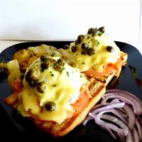 Lox Benedict · Focaccia bread, smoked salmon, tomato, poached eggs, capers, red onions, hollandaise sauce &...