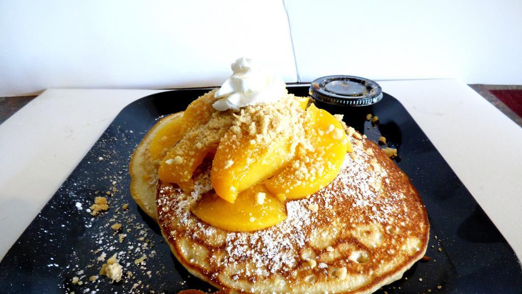 Peach Cobbler Pancakes · Two buttermilk pancakes with peaches and maple streusel