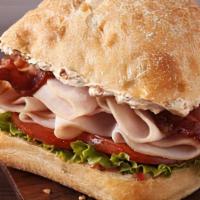 Turkey Club · Oven roasted turkey breast, bacon, Swiss cheese, lettuce, tomato, red onion & house dressing...