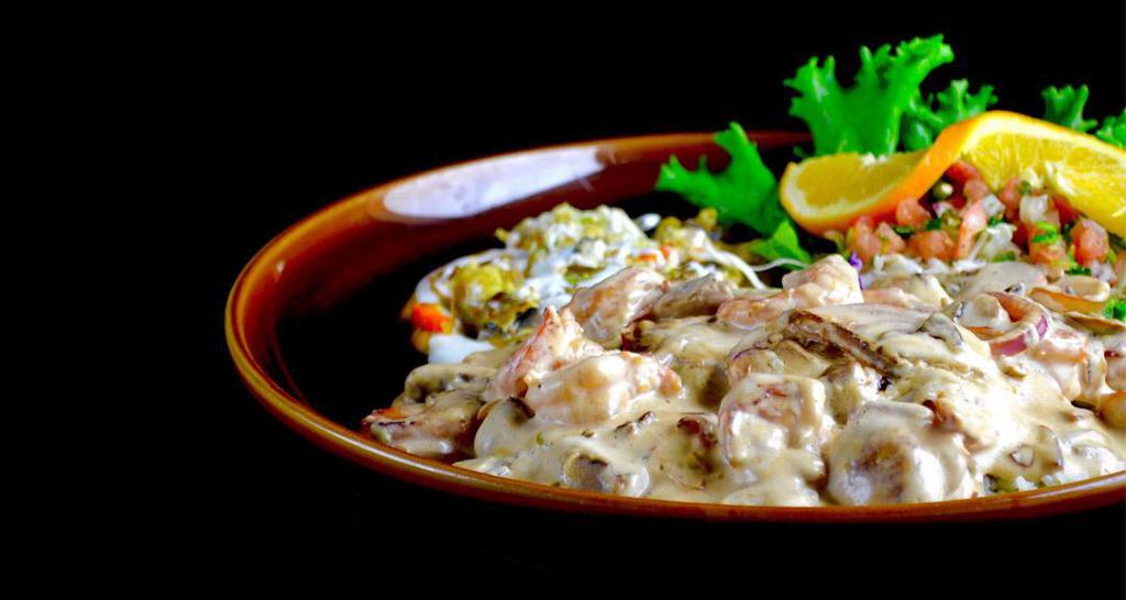 Camarones Blancos · A delectable mix of sautéed shrimp, mushrooms, onions, green peppers and carrots over white rice, nestled in a light, creamy jalapeño sauce. Not served with beans.