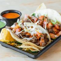 Carne Asada Taco · Angus beef, grilled to perfection in a taco topped with onions, cabbage, cilantro, fresh sal...