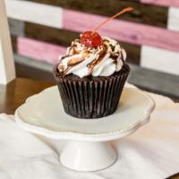 Hot Fudge Sundae Cupcake · Our moist chocolate cake filled with fudge topped with vanilla buttercream, a fudge drizzle,...