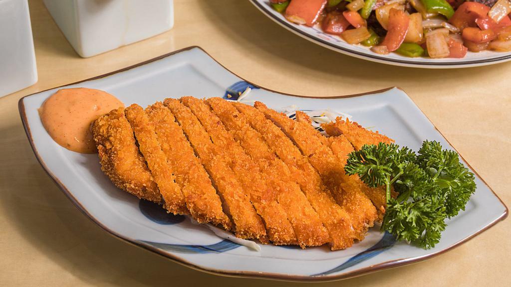 Pork Chop Fried Rice · Perfectly seasoned and textured fried rice meets the irresistible aromas of fried eggs and freshly-chopped green onion. Topped with our signature Shanghainese-style fried pork cutlet that is crispy on the outside with a tender, juicy center.