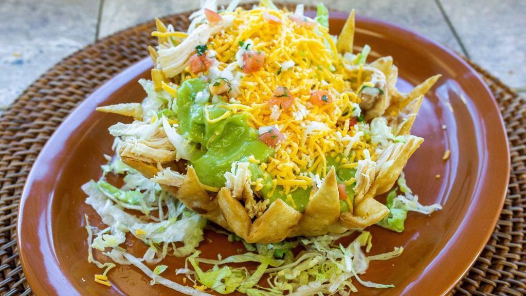 #27 Taco Salad · With beans,guacamole,salsa mexicana (pico de gallo),lettuce,cheddar cheese,and enchilada cheese