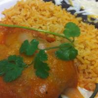 Chile Relleno · Roasted pasilla chile stuffed with cheese and cooked in roasted tomato sauce. Served with ri...