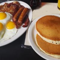The Deck Hand · Three extra-large eggs any style, two strips of bacon, two links, two hotcakes and hash brow...