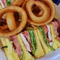 Turkey Club Sandwich · Turkey, bacon, lettuce and tomatoes on three slices of toasted bread.