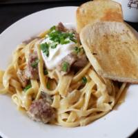 Beef Stroganoff · Tenderloin tossed with fettuccine in a mushroom cream sauce and topped with sour cream and g...