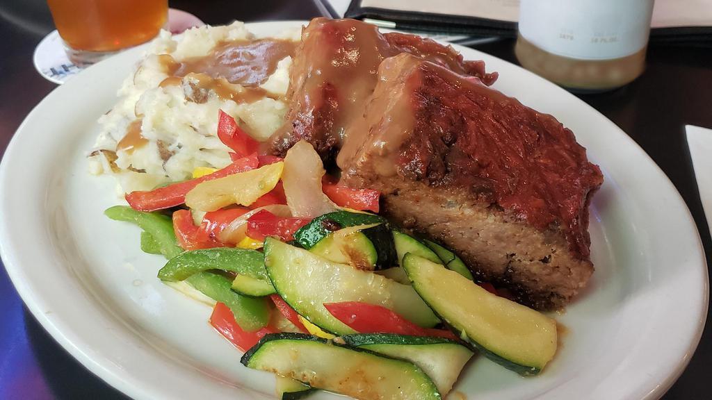 Blue Plate Meatloaf · Ground beef cooked with our secret seasonings served with mashed potatoes, beef gravy and veggies.