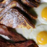 Uptown Slam · Two pancakes or two slices of French toast, with choice of 2 strips of bacon or 2 sausage li...