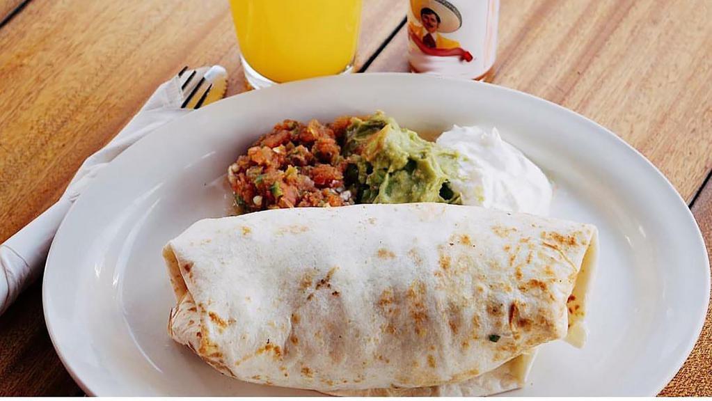 Breakfast Burrito · 3 scrambled eggs, red potatoes, spicy black beans and pico de gallo in a large flour tortilla topped with guacamole, sour cream and salsa rojo on the side.