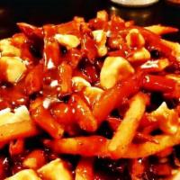 Poutine · Half pound of our hand-cut fries topped with cheese curds and smothered with hot beef gravy.