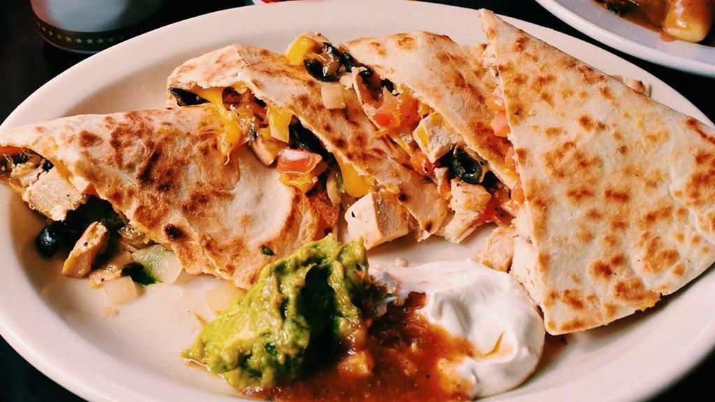 Chicken Quesadilla · One large grilled flour tortilla loaded with cheddar cheese, black olives, fresh pico de gallo, diced chicken breast and jalapenos accompanied by salsa, sour cream and guacamole.