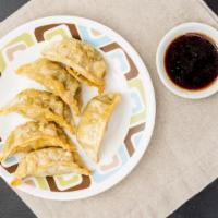 Potstickers (6) · A filled Chinese dumpling, typically crescent-shaped served with black sweet sauce.