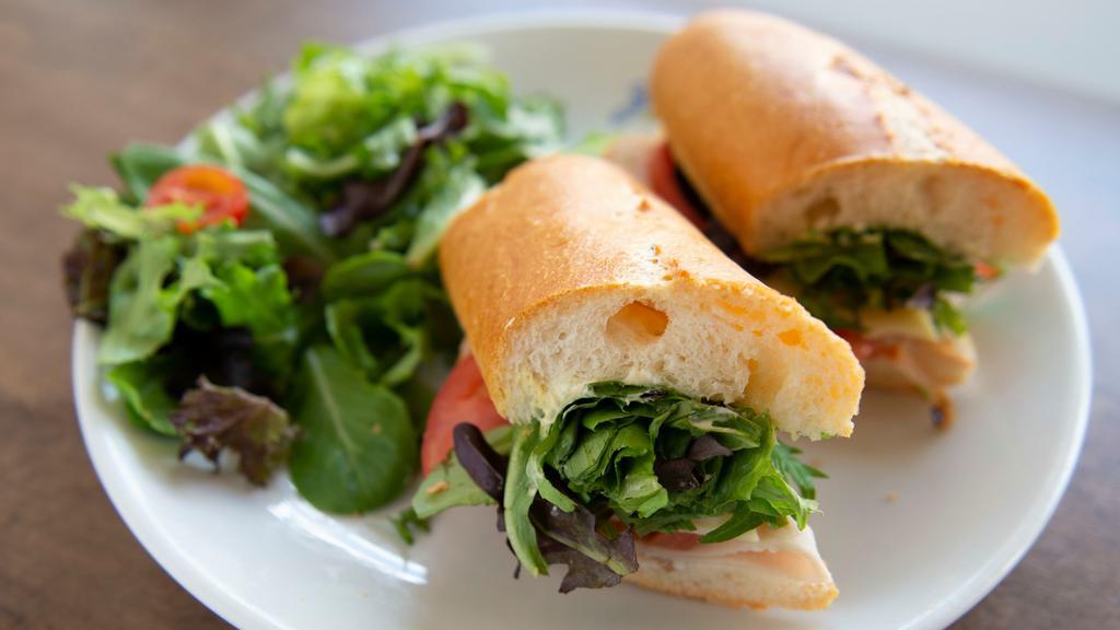 Roasted Turkey & Swiss · Roasted Turkey, Mixed Greens, Tomato, Swiss Cheese, Mustard, Mayonnaise on Baguette. Served with Side Salad with Balsamic Vinaigrette dressing.