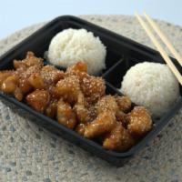 Sesame Chicken · Deep-fried chicken sautéed in a sweet sauce and topped with sesame seeds, served with rice.