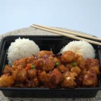 General Tso Chicken · Deep-fried chicken sautéed with peas and carrots in a mildly spicy sauce, served with rice.