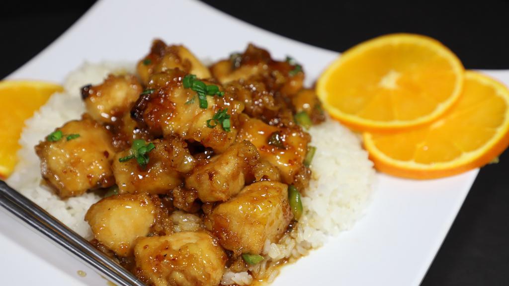 Orange Chicken · Tempura chicken pieces coated with a sweet and sour orange flavored chili sauce, served on bed of white rice.