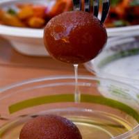 Gulab Jamun · Milk-based pastry balls with honey-flavored syrup.
