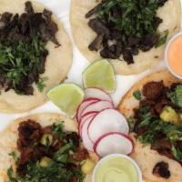 Taco Plate · Two tacos with your choice of meat, cilantro, onion, and radishes, with a side of rice and b...