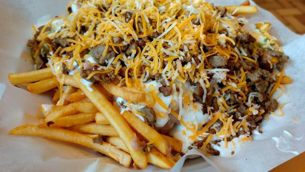 Carne Asada Fries · With carne asada meat, pico de gallo and cheddar cheese on a large order of fries.