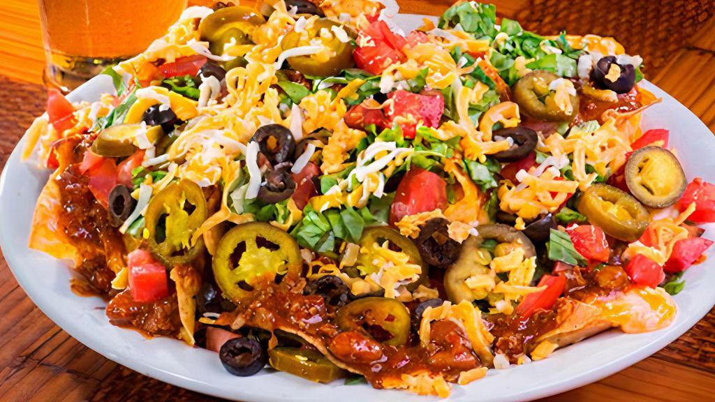 Nachos Supreme · Tortilla chips with taco meat, beans, pico de gallo and cheddar cheese.