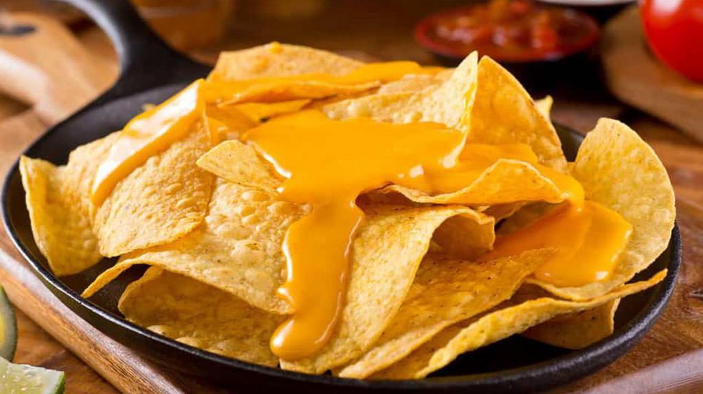 Nachos With Cheese · Nacho cheese on tortilla chips.