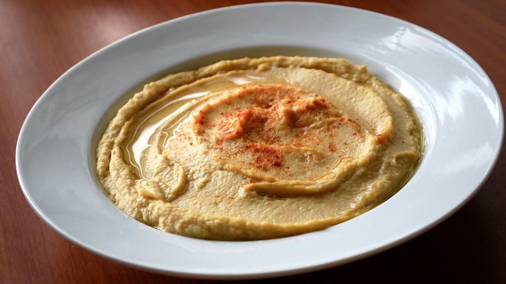 Famous Hummus With 2 Sides Of Pita · Our famous homemade hummus, with two side pita bread. Mom's homemade recipe, made with chickpeas, tahini, olive oil, freshly squeezed lemon & garlic, this is a true vegetarian treat!