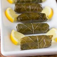 Greek Vegetarian Dolmas (6 Pcs) · With side of tzatziki sauce. Famous Greek vegetarian dolmas, made with rice, wrapped in grap...