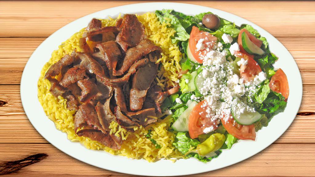 Gyros Plate With Pita · Famous gyros on yellow rice with Greek salad and pita bread. Served with a side of homemade Greek dressing and tzatziki sauce. Greek salad includes: romaine lettuce, tomato, bell peppers, cucumbers, pepperoncini, olives and feta cheese.