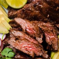 Carne Asada · Seasoned flank steak served with rice, beans, and side of guacamole, sour cream, and lettuce.