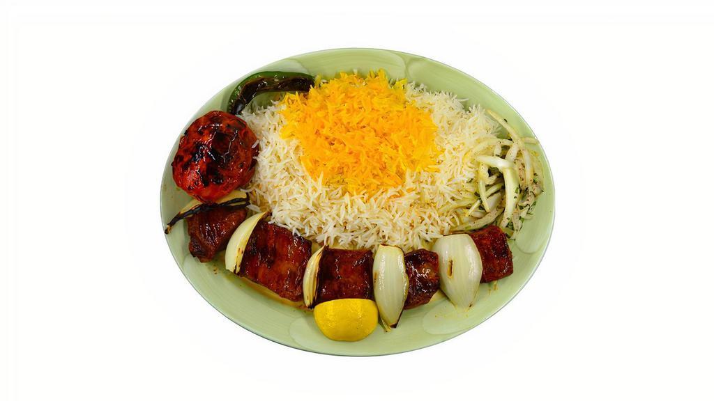 Lamb Shish Kabob · Chunks of marinated lamb charbroiled over open fire, served with grilled onions, basmati rice topped with saffron flavored rice, grilled tomato, and serrano pepper.