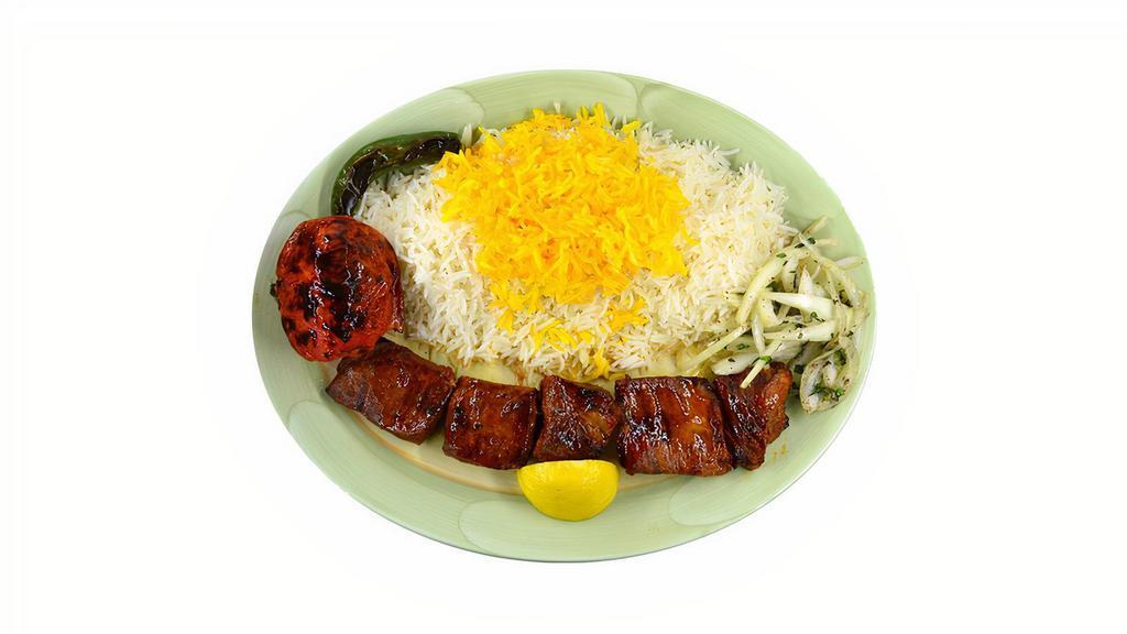 Shish Kabob · Chunks of marinated beef charbroiled over open fire, served with basmati rice topped with saffron flavored rice, grilled tomato, and serrano pepper.