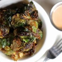 Brussels Sprouts** · Crispy Brussels Sprouts tossed in lemon olive oil , served with a side Green Goddess Sauce