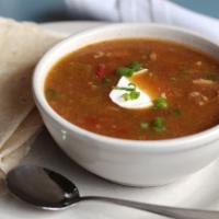 Green Chili Stew** · Served with a side of tortilla, sour cream and green onion garnish