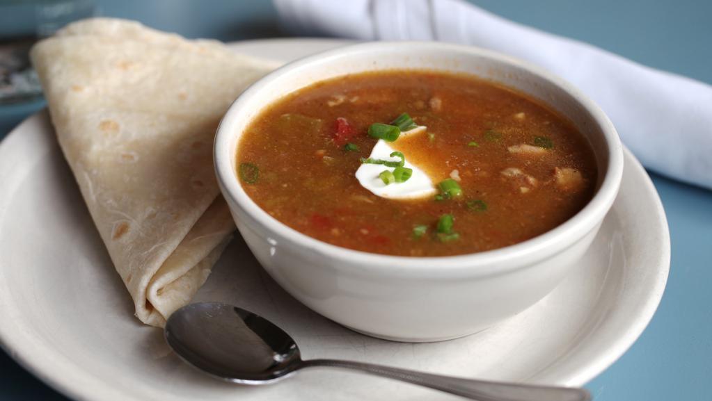 Green Chili Stew** · Served with a side of tortilla, sour cream and green onion garnish